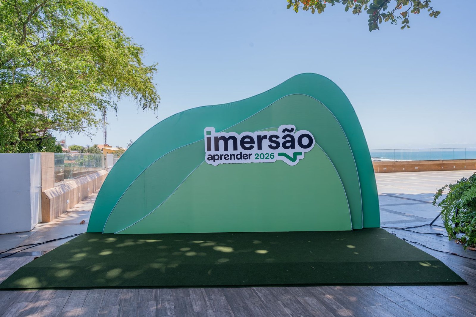 Inflável verde da Imersão Aprender instalado em deque com o mar ao fundo